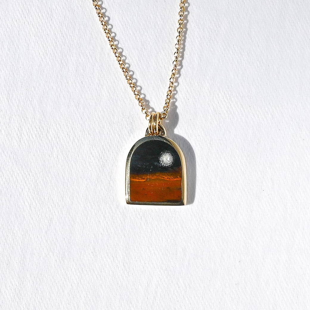Pendant featuring a night scene made of stone