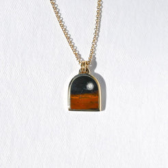 Pendant featuring a night scene made of stone
