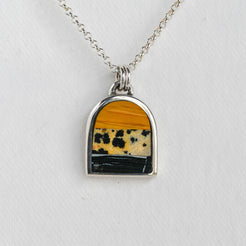 Necklace with a pendant featuring a multicolored stone on a white background