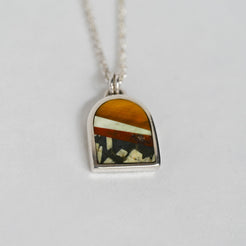 Necklace with a pendant featuring a multicolored stone on a white background
