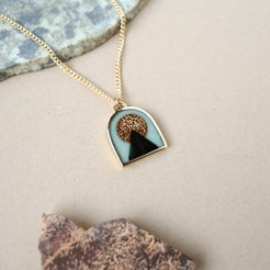 Necklace with a pendant on a neutral background