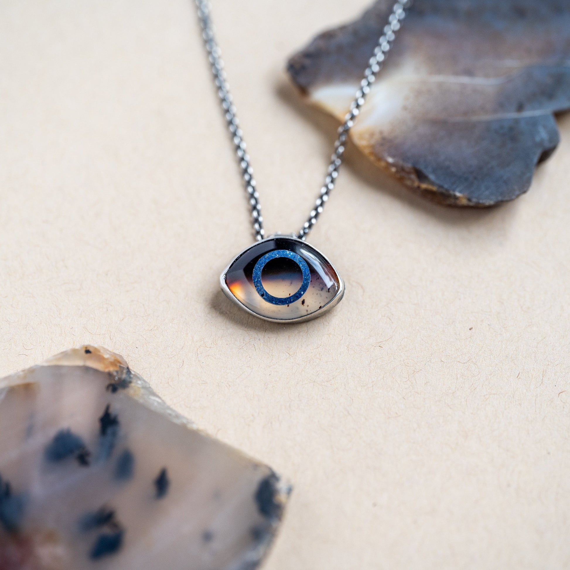 Necklace with a Montana Agate eye pendant set in sterling silver on a light background