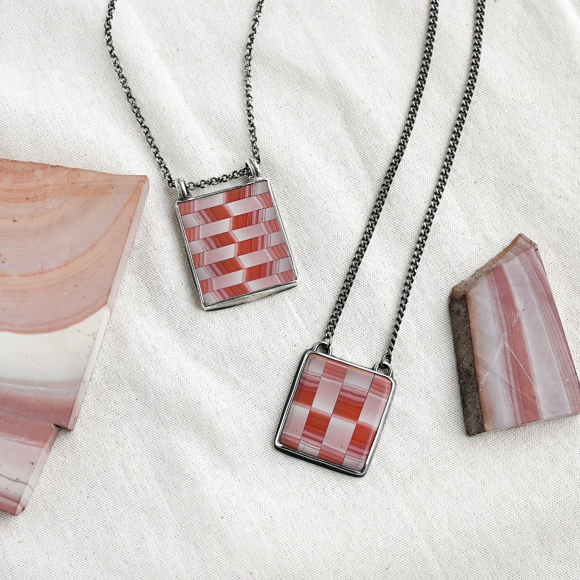 cream and red colored wonderstone pendants